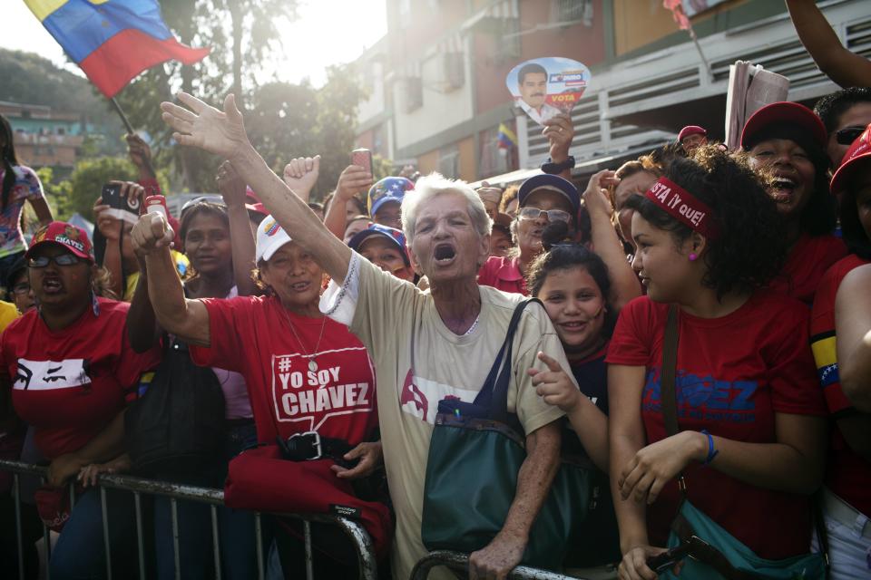People chant pro-government slogans outside the mausoleum of the late Venezuelan President Hugo Chavez in Caracas, Venezuela, Wednesday, March 5, 2014. To mark Chavez's passing, President Nicolas Maduro has decreed a 10-day-long commemoration - three days more than the weeklong official mourning period following his death at age 58 on March 5, 2013. (AP Photo/Rodrigo Abd)