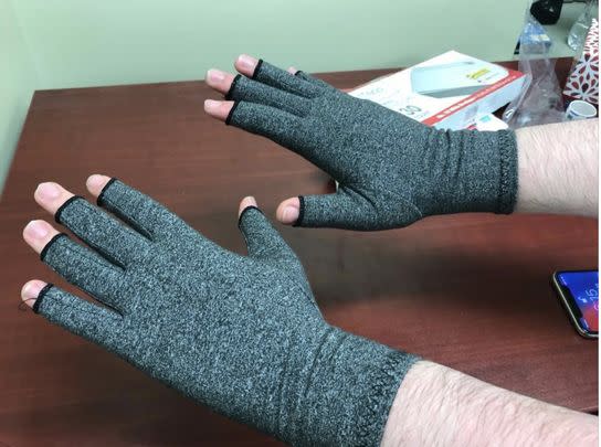 A pair of compression gloves to relieve pain caused by arthritis, carpal tunnel, and tendonitis.