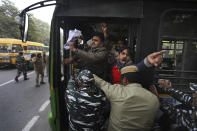 Policemen detain students protesting outside Uttar Pradesh Bhawan during a protest against a new citizenship law and violence by police in the state, in New Delhi, India, Friday, Dec. 27, 2019. The new citizenship law allows Hindus, Christians and other religious minorities who are in India illegally to become citizens if they can show they were persecuted because of their religion in Muslim-majority Bangladesh, Pakistan and Afghanistan. It does not apply to Muslims. (AP Photo/Manish Swarup)