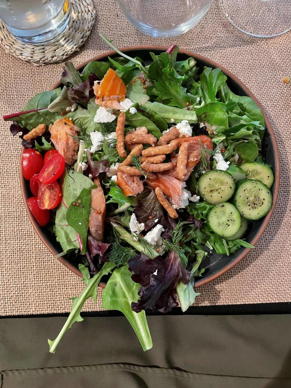 A salad of smoked salmon, fresh goat cheese, arugula, cucumber and a dill-lemon dressing helped get a recent Under The Table dinner underway.