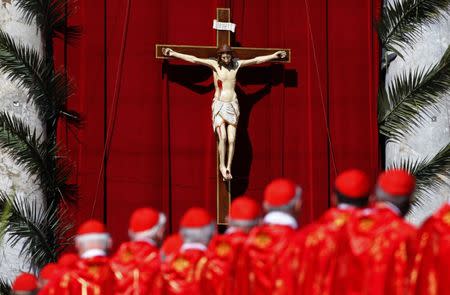 FILE PHOTO: Cardinals attend the Palm Sunday Mass led by Pope Francis in Saint Peter's Square at the Vatican April 9, 2017. REUTERS/Tony Gentile