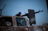 A member of the Islamist Syrian opposition group Ahrar al-Sham fires against a Kurdish militia during clashes in the northern Raqqa province on August 25, 2013. The United States and its allies built their case Wednesday for likely military action against the regime in war-torn Syria over alleged chemical weapons attacks, despite stern warnings from Russia