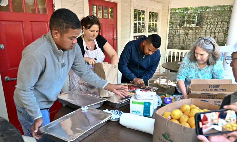 Volunteers present food for migrants at St. Andrews Parish Hall in Edgartown Thursday morning.
