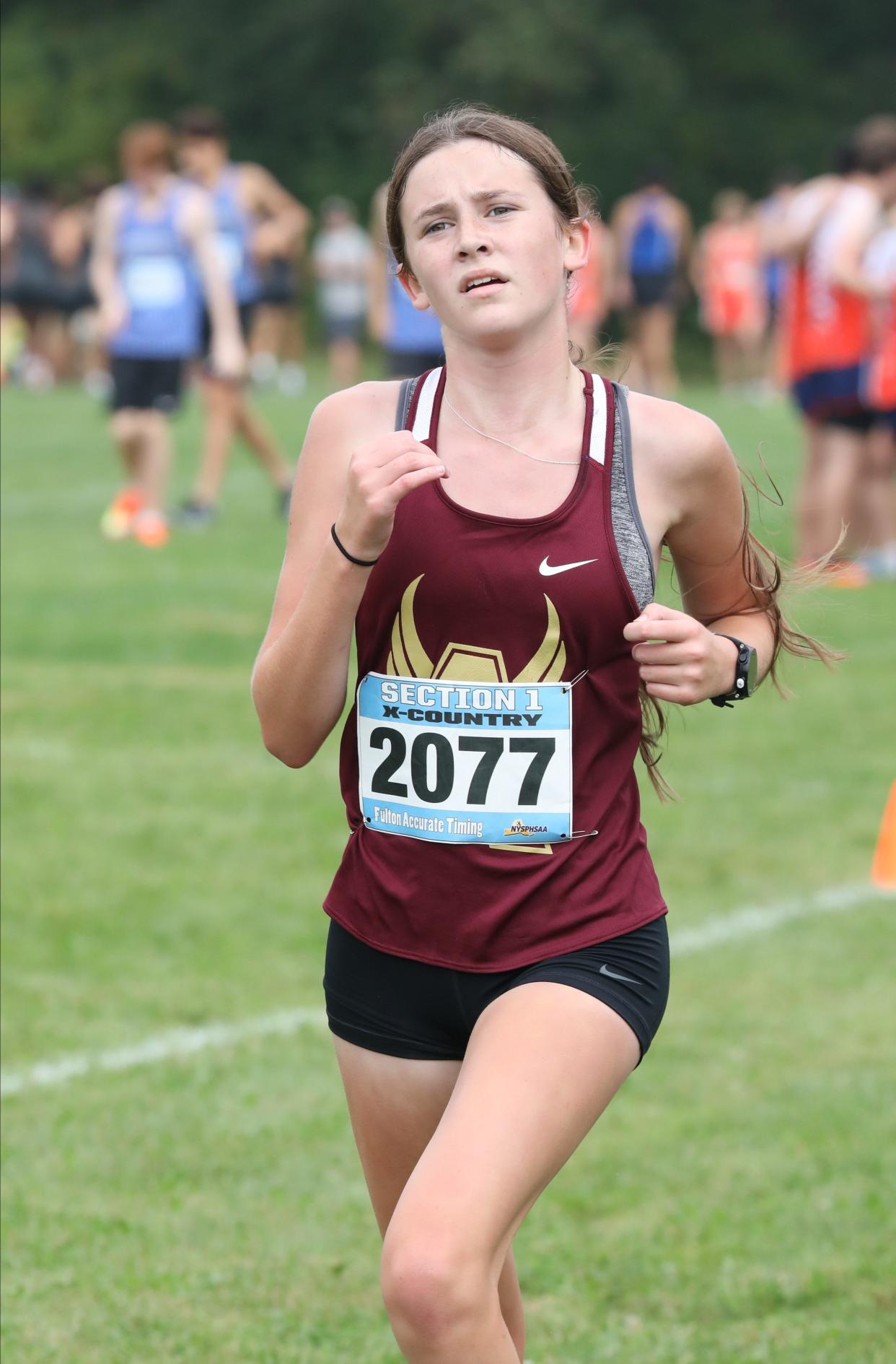 Bailey Guckian from Arlington crosses the finish line during the girls D1 race at the Somers Big Red Invitational Cross Country meet at Somers High School, Sept. 9, 2023.