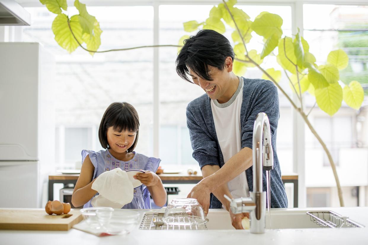 Father and daughter doing the dishes