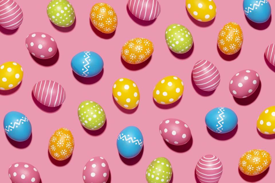 handmade decorated easter eggs on pink background