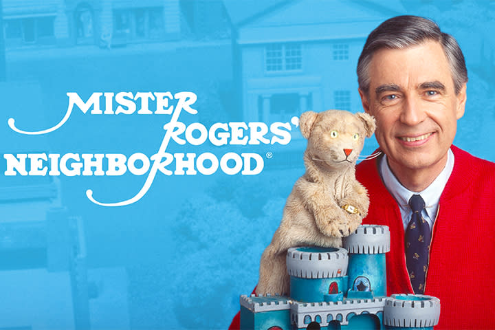 Promotional poster for Mister Rogers' Neighborhood featuring Fred Rogers with a puppet smiling.