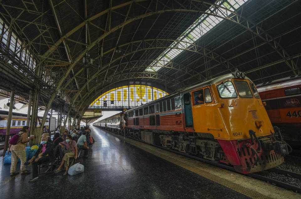 Passengers wait on a bench on the open air platform at the Hua Lamphong railway station in Bangkok, Thailand, Tuesday, Jan. 17, 2023. As Thailand officially opened what is said to be Southeast Asia's largest train station in Bangkok, Thursday, Jan. 19, 2023, the century-old iconic station will still be used for local operations for the time being. (AP Photo/Sakchai Lalit)