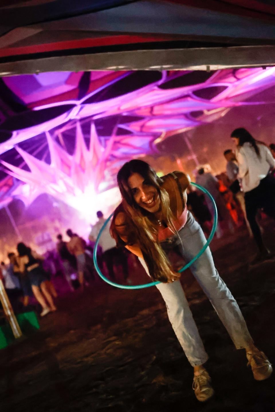 woman with hula hoop smiling at festival