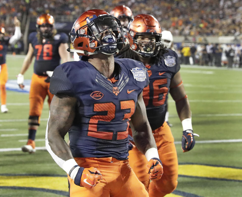 Syracuse running back Abdul Adams (23) celebrates after scoring a touchdown on a 1-yard run against West Virginia during the first half of the Camping World Bowl NCAA college football game Friday, Dec. 28, 2018, in Orlando, Fla. (AP Photo/John Raoux)