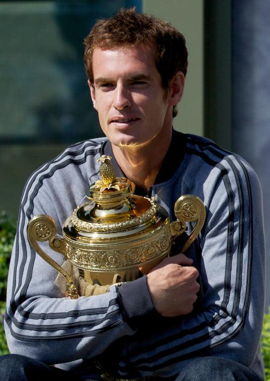 Andy Murray poses with the 2013 Wimbledon trophy