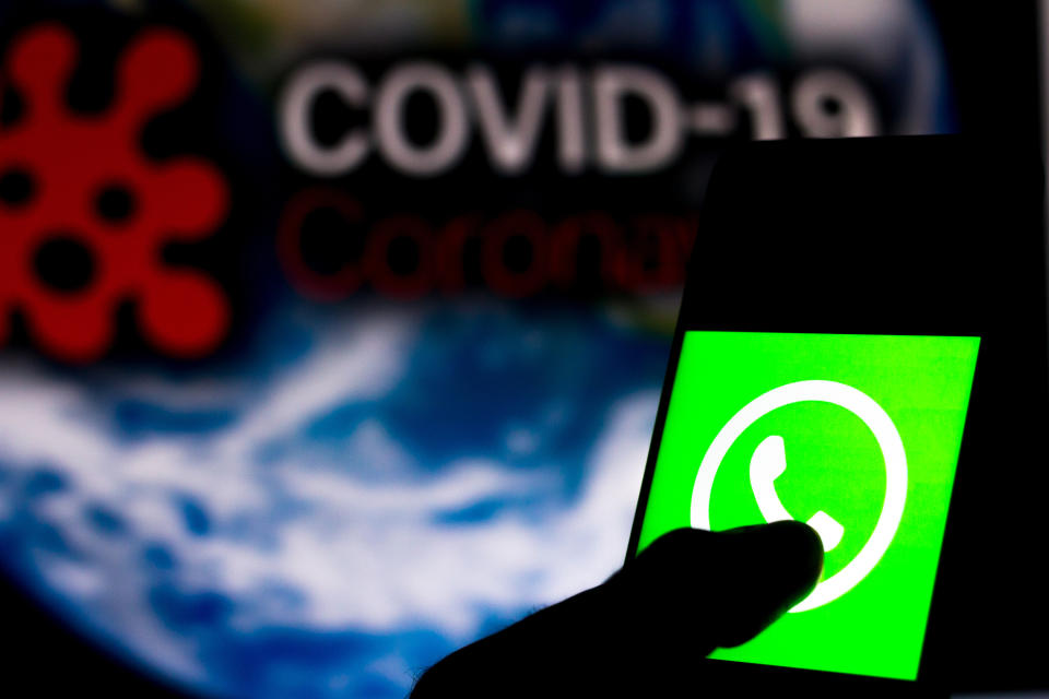 BRAZIL - 2020/04/05: In this photo illustration the WhatsApp logo seen displayed on a smartphone with a computer model of the COVID-19 coronavirus in the background. (Photo Illustration by Rafael Henrique/SOPA Images/LightRocket via Getty Images)