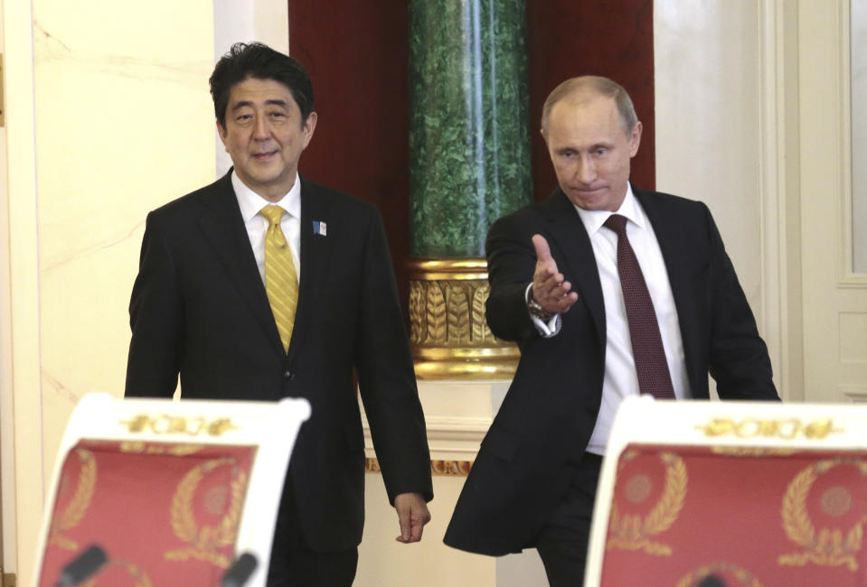 FILE - Russian President Vladimir Putin, right, and visiting Japanese Prime Minister Shinzo Abe walk in a hall to take part in a final news conference in Moscow's Kremlin, Monday, April 29, 2013. Former Japanese Prime Minister Abe, a divisive arch-conservative and one of his nation's most powerful and influential figures, has died after being shot during a campaign speech Friday, July 8, 2022, in western Japan, hospital officials said.(AP Photo/Ivan Sekretarev, File)