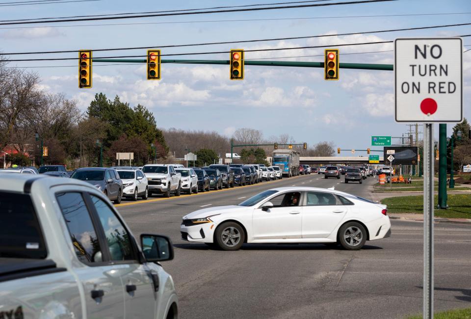 Dozens of cars drive through Ford Road in Canton on Tuesday, April 9, 2024. The Michigan Department of Transportation plans to spend $65 million to rebuild 2.5 miles of Ford Road.