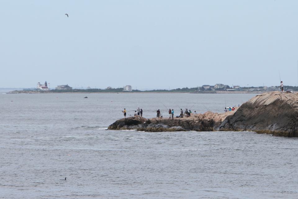 With Point Judith as a backdrop, surfcasters descend on Black Point, a state fishing area in Narragansett, in July 2010.
