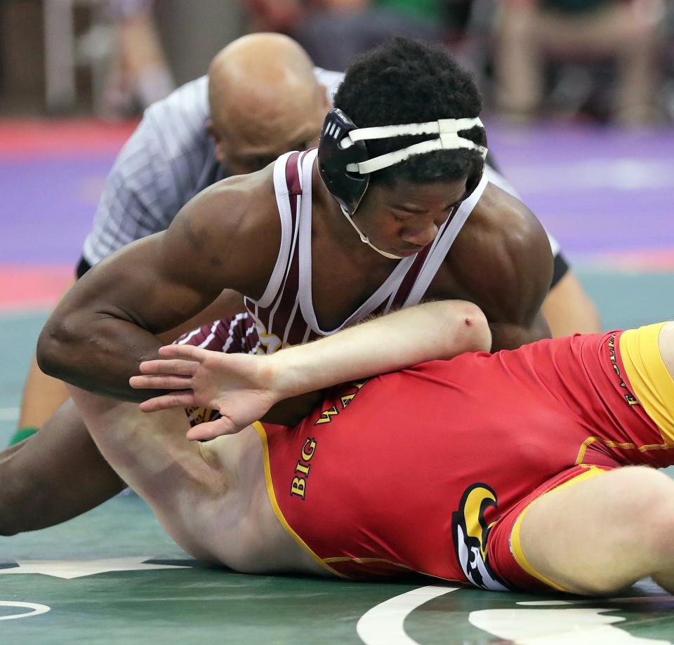 Walsh Jesuit's Dy'Vaire VanDyke, top, works over Sunbury Big Walnut's Vince Giordano during their 138-pound preliminary match on Day One of the OHSAA State Wrestling Tournament last season.