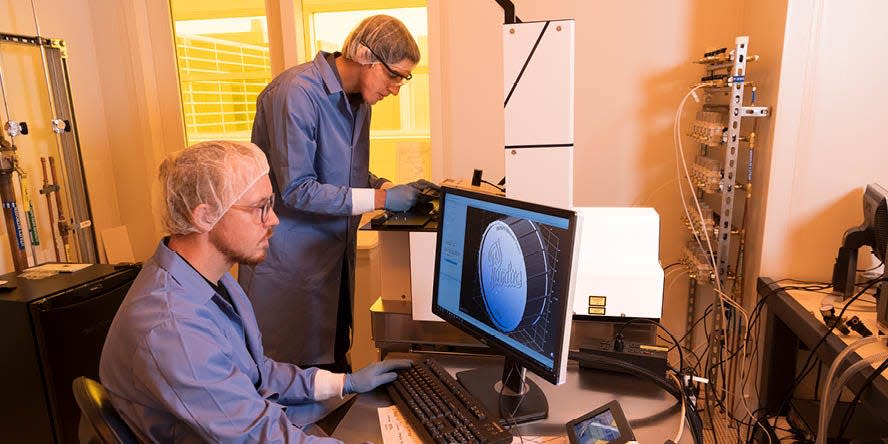 Aaron Davis (left), a mechanical engineering PhD student, in the lab alongside Georges Adam.