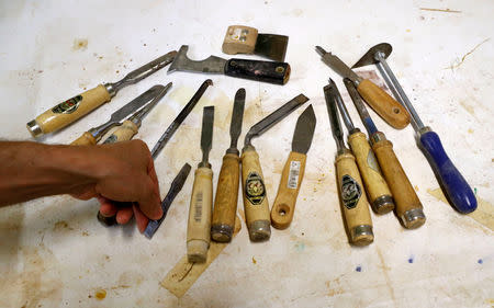 Joseph Saliba, a Syrian migrant of Christian background sorts his tools in a workshop inside the Berlin Cathedral in Berlin, Germany, August 3, 2018. REUTERS/Fabrizio Bensch