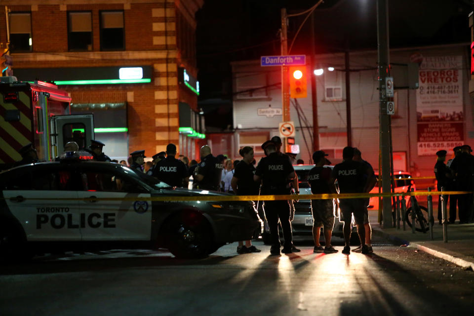 Police are seen near the scene of a mass shooting in Toronto, Canada, on Sunday. (Photo: Chris Helgren / Reuters)