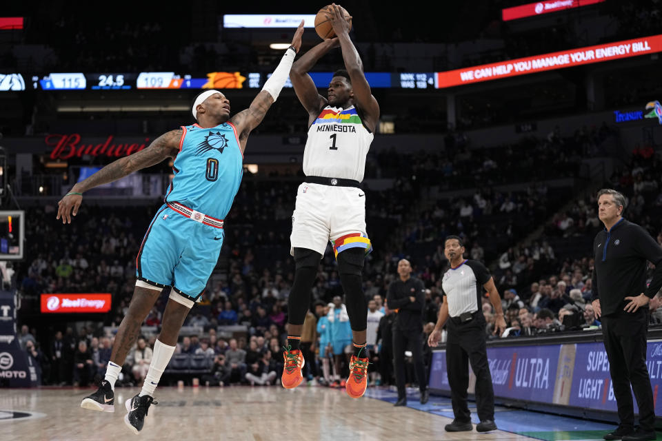 Minnesota Timberwolves guard Anthony Edwards (1) shoots against Phoenix Suns forward Torrey Craig (0) during the second half of an NBA basketball game, Friday, Jan. 13, 2023, in Minneapolis. (AP Photo/Abbie Parr)