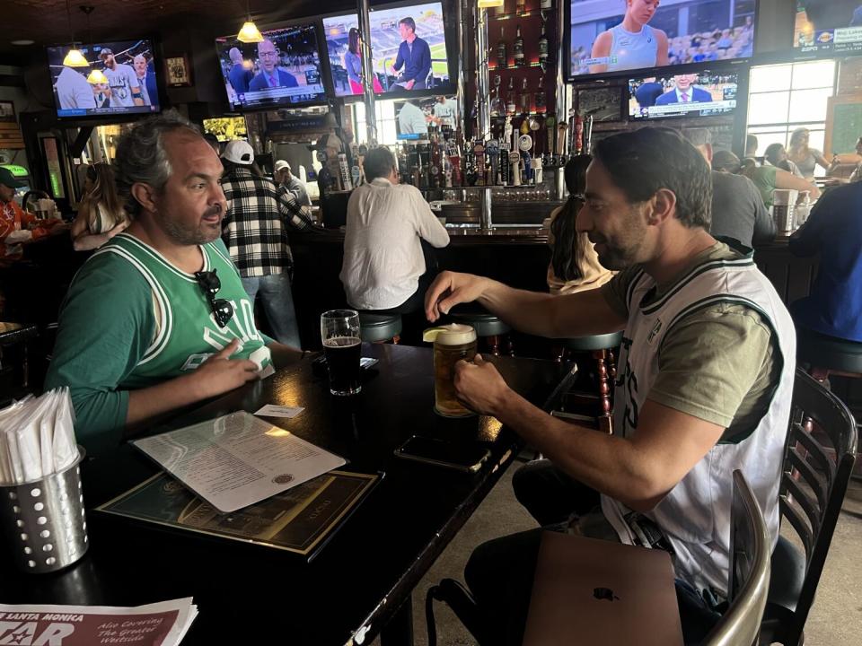 Two Celtics fans sit at a table at Sonny McLean's Irish Pub in Santa Monica