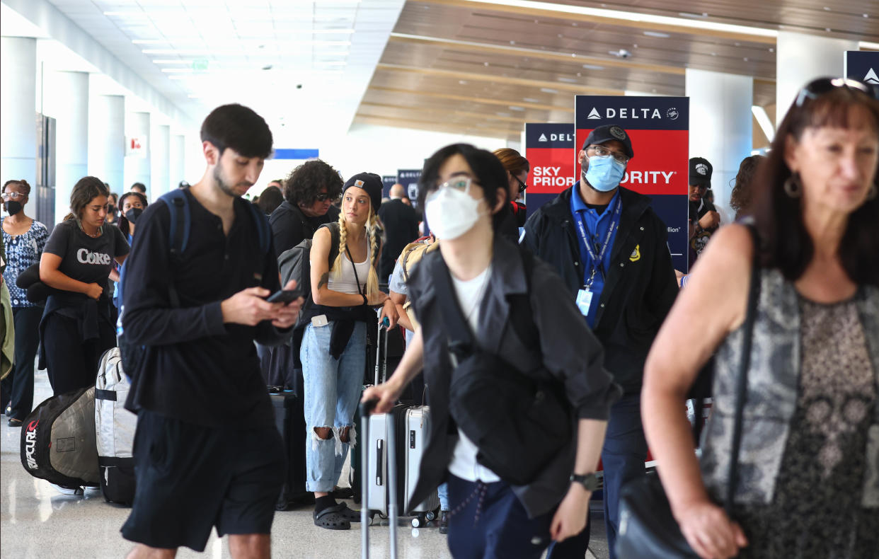 Travelers gather in the Delta terminal at Los Angeles International Airport (LAX) on June 30, 2022 in Los Angeles, California. Flight cancellations and delays were increasing ahead of the busy Fourth of July travel weekend amid airline staffing shortages. (Photo by Mario Tama/Getty Images)