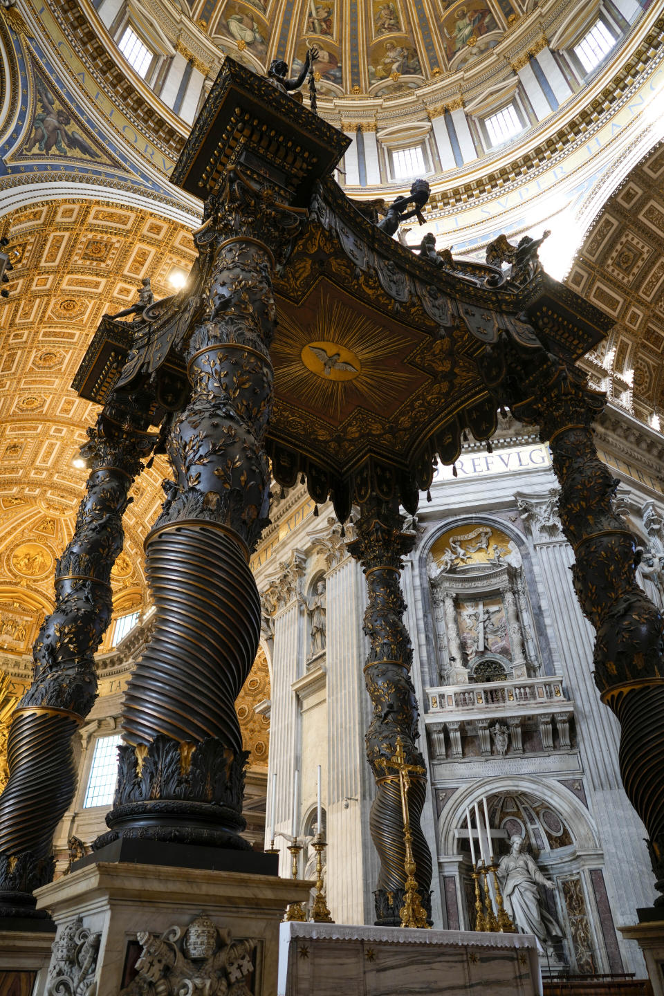 A view of the 17th century, 95ft-tall bronze canopy by Giovan Lorenzo Bernini surmounting the papal Altar of the Confession in St. Peter's Basilica at the Vatican, Wednesday, Jan. 10, 2024. Vatican officials unveiled plans Thursday, Jan.11, for a year-long, 700,000 euro restoration of the monumental baldacchino, or canopy, of St. Peter's Basilica, pledging to complete the first comprehensive work on Bernini's masterpiece in 250 years before Pope Francis' big 2025 Jubilee. (AP Photo/Andrew Medichini)