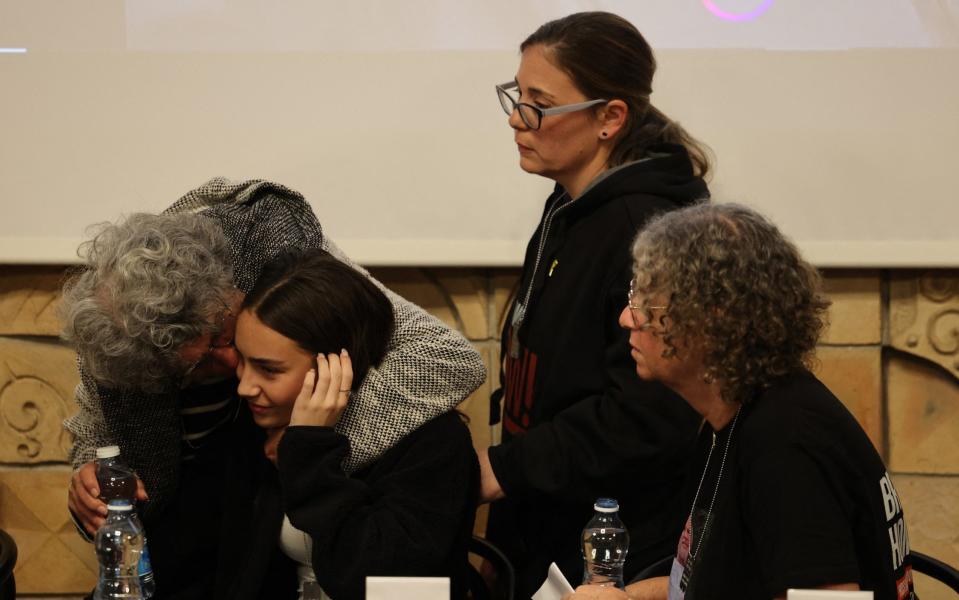 Former hostage Adina Moshe gives Sahar Calderon a hug as Aviva Siegel and Nili Margalit look on, following a conference organised by five women abducted by Hamas on Oct 7 and later released