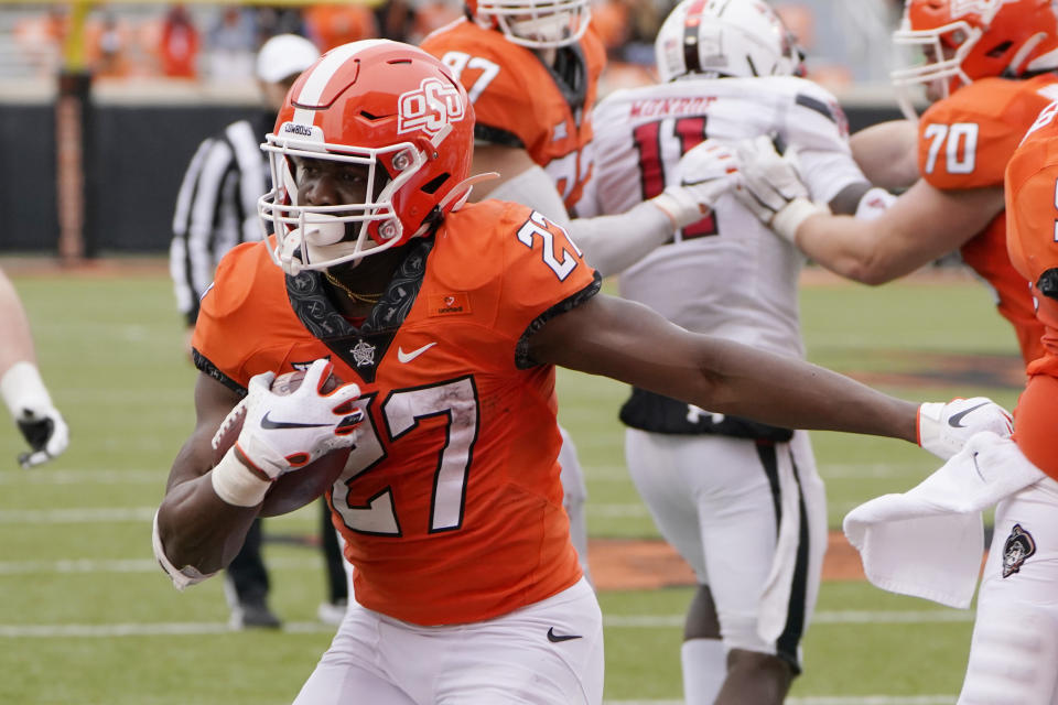 Oklahoma State running back Dezmon Jackson (27) scores against Texas Tech in the first half of an NCAA college football game in Stillwater, Okla., Saturday, Nov. 28, 2020. (AP Photo/Sue Ogrocki)