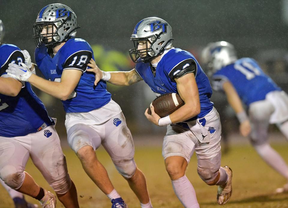 Bartram Trail's Laython Biddle (33) gets a little blocking help from teammate Jacob Kallner (18) as he runs for a first down during third quarter action. The Bartram Trail Bears football team hosted Gainesville's Buchholz Bobcats at the Bears Saint Johns stadium Friday, November 25, 2022. With the Buchholz's Friday night 21 to 20 win in the FHSAA Region 1-4S high school football final, the Bobcats's advance to the final four. [Bob Self/Florida Times-Union]