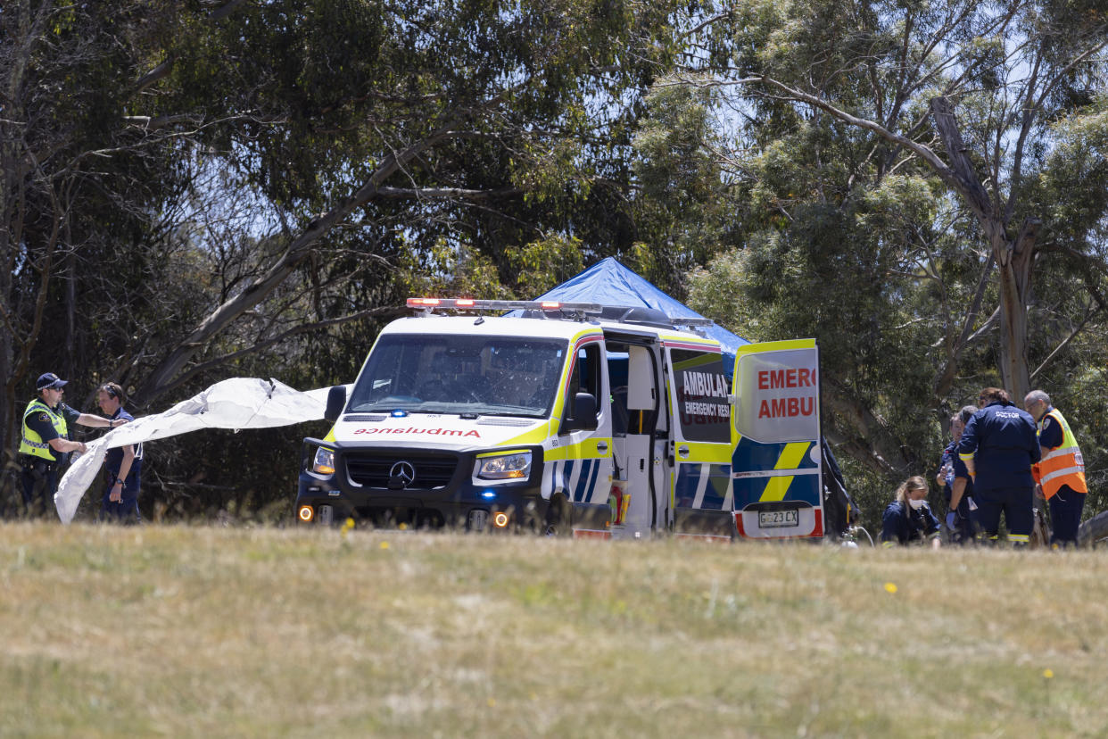 Emergency services personnel work the scene of a deadly incident involved with a bouncy castle at the Hillcrest Primary School in Devonport, Tasmania, Thursday, Dec. 16, 2021. Multiple children have died and others are in critical condition after falling from a bouncy castle that was lifted 10 meters (33 feet) into the air by a gust of wind at a junior school on the island state of Tasmania on Thursday. (Grant Wells/AAP Image via AP)