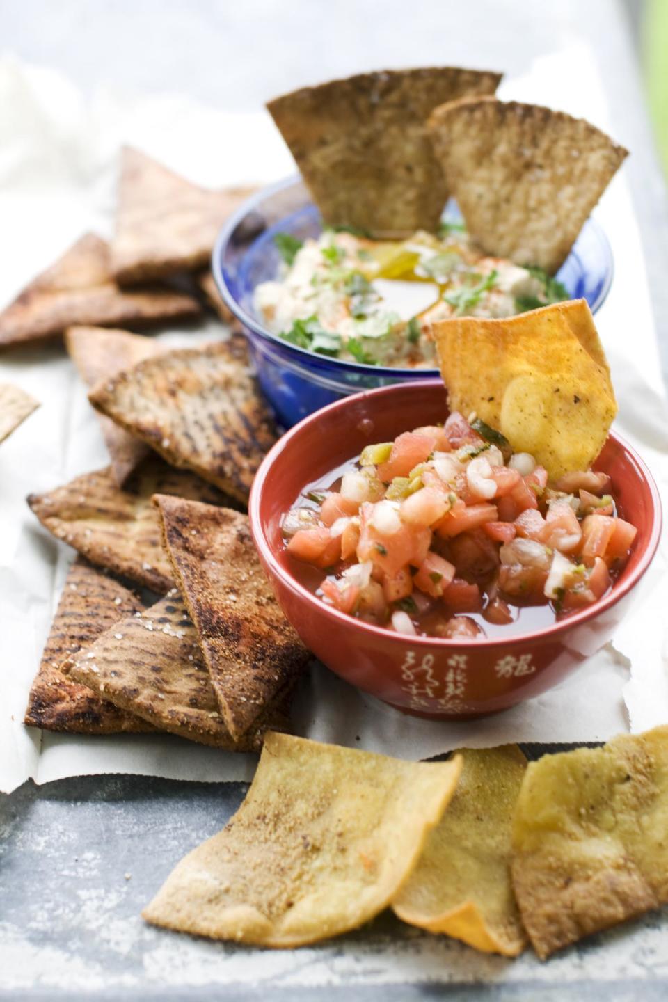 In this image taken on June 10, 2013, baked whole wheat pita chips, left, baked whole wheat tortilla chips, top right, and fried tortilla chips with cinnamon sugar are shown in Concord, N.H. (AP Photo/Matthew Mead)