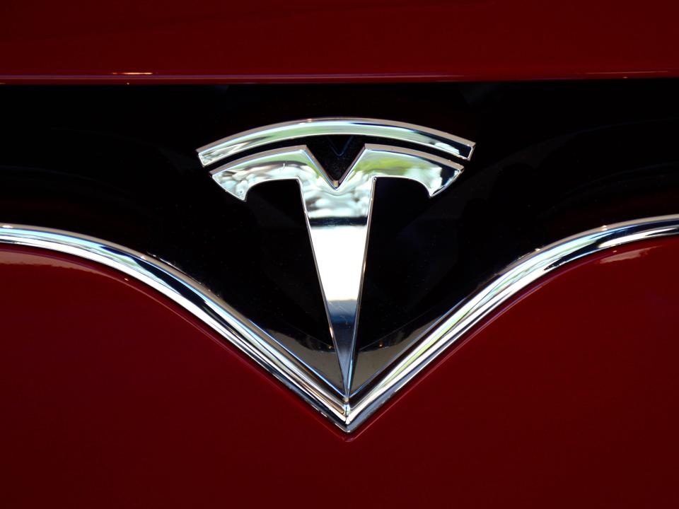 Tesla logo on the nose of a vehicle