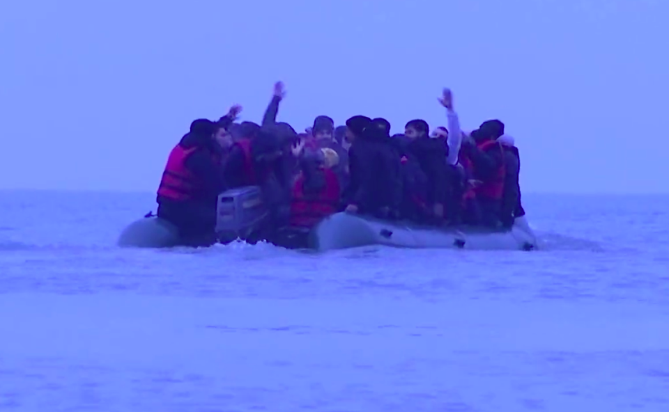 Migrants wave as they leave the French shore on their way to the UK. (Reuters)