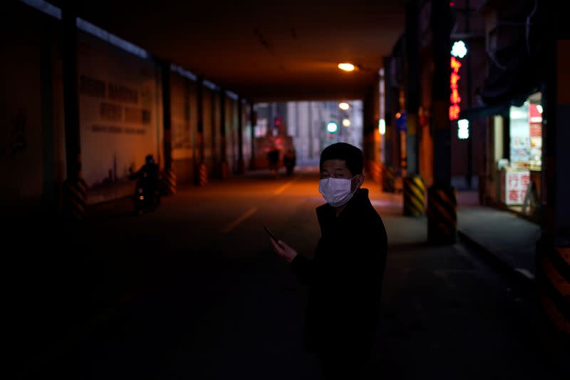 A man wearing a mask is seen on a street in Shanghai