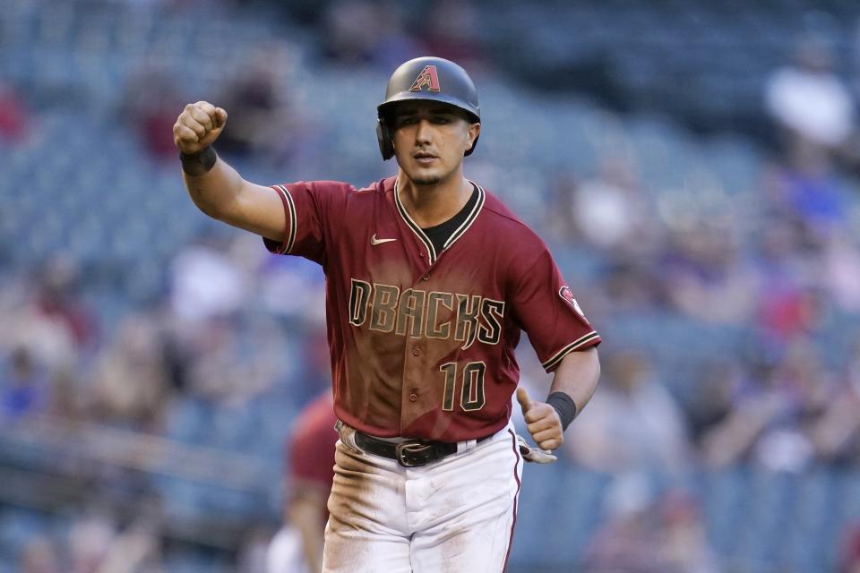 Arizona Diamondbacks' Josh Rojas pumps his fist as he scores a run against the Miami Marlins during the first inning of a baseball game Wednesday, May 12, 2021, in Phoenix. (AP Photo/Ross D. Franklin)