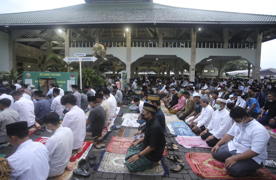 Muslim men perform Eid al-Adha prayers at a mosque in Denpasar, Bali, Indonesia, Sunday, July 10, 2022. Muslim people in the country celebrate Eid al-Adha, or the Festival of the Sacrifice, by slaughtering sheep, goats and cows, whose meat later will be distributed to the poor. (AP Photo/Firdia Lisnawati)