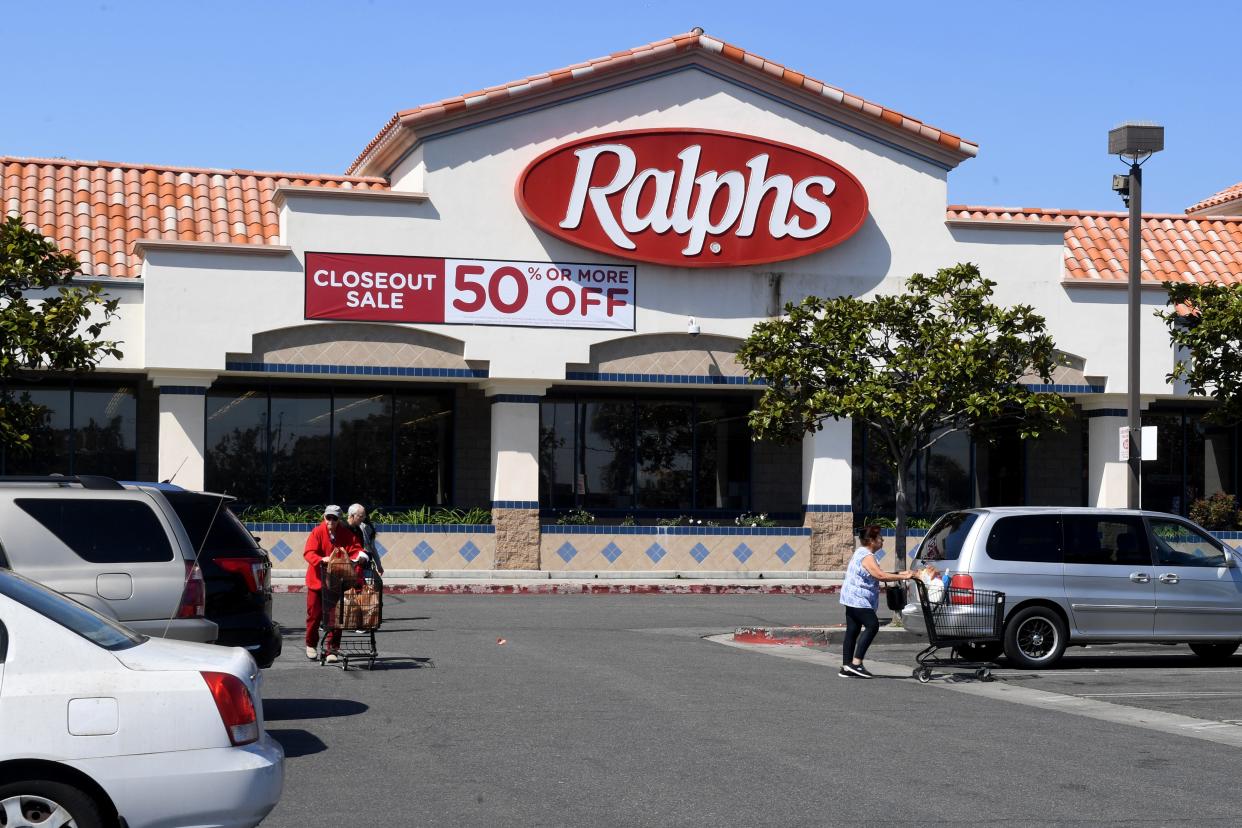 Shoppers push grocery carts through the parking lot at Ralphs on Saviers Road in Oxnard on Tuesday. The store is closing in June.