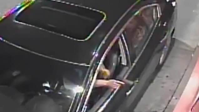 Security footage shows the woman pointing a gun while in the drive-thru. (Photo: WSB-TV)