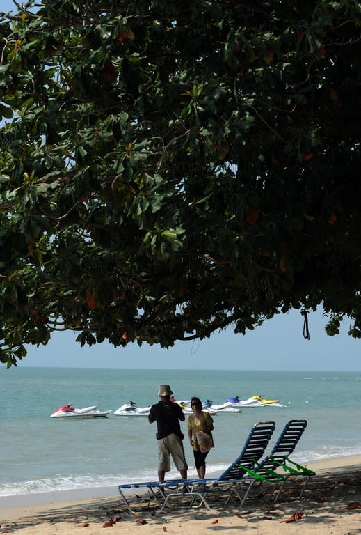 Foreigners are seen enjoying an afternoon at Ferringhi beach near George Town on Penang resort island in Malaysia, on August 26, 2010. With its warm climate, political stability and modern economy, Malaysia has drawn 19,488 foreigners to settle in the country since launching the Malaysia My Second Home (MM2H) programme 10 years ago