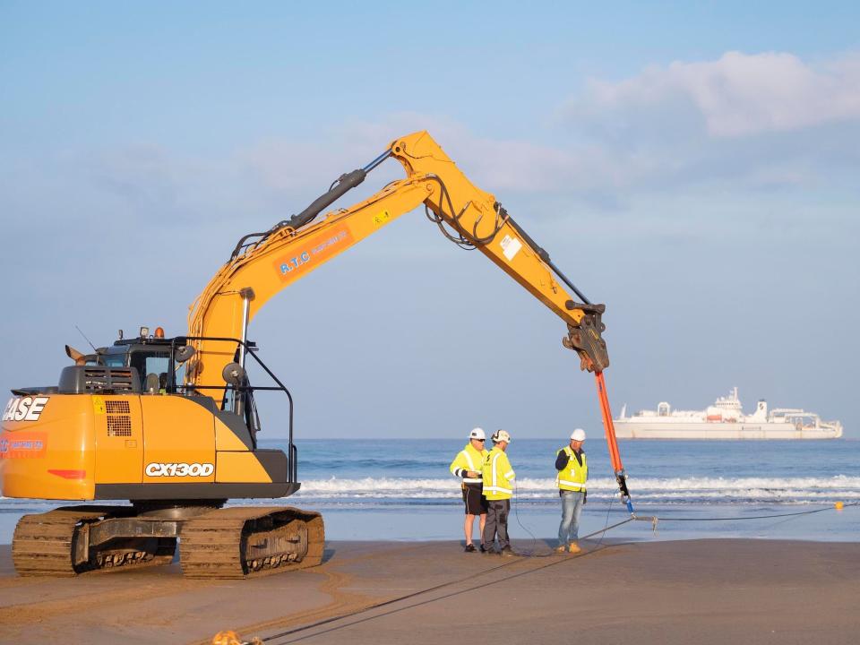 A machine helps land Google's Grace Hopper cable on the coast of the UK.