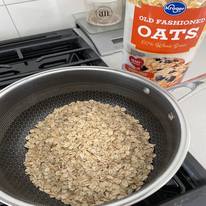 Dry oats in a pot on the stove