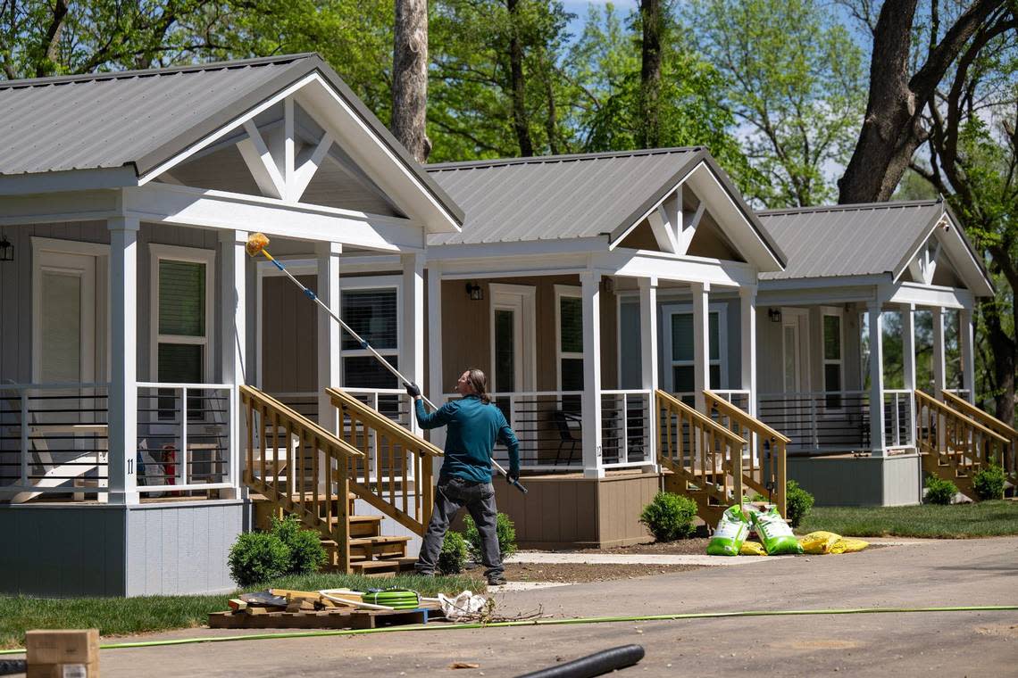 Brian Wright of Nomo Pest Solutions, works on a tiny home at Eden Village of Kansas City on Wednesday, April 17, 2024. The community of 21 tiny homes, will open in June and provide stable housing for the chronically homeless in Kansas City, Kansas.