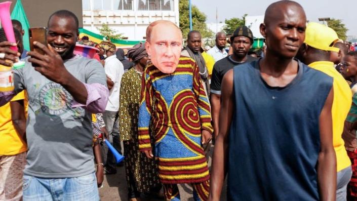 A supporter of Malian Interim President wears a face mask of the President of Russia, Vladimir Putin, during a pro-Junta and pro-Russia rally in Bamako on May 13, 2022