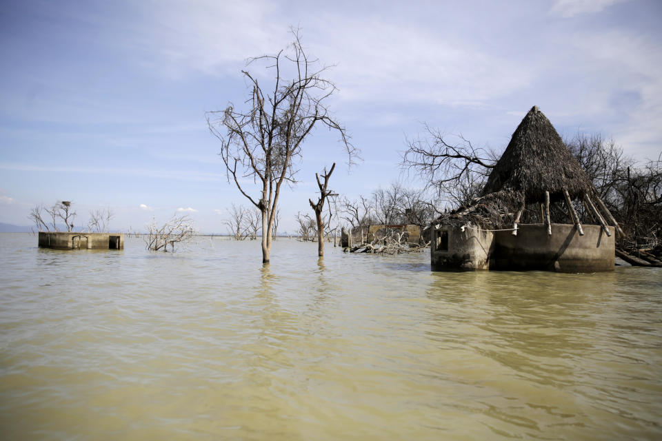 FILE - An old hotel is submerged by rising water levels in Lake Baringo in Kampi ya Samaki, Kenya, July 20, 2022. Battling droughts, sandstorms, floods, wildfires, coastal erosion, cyclones and other weather events exacerbated by climate change, the African continent needs to adapt, but it needs funds to do so. It’s one of the main priorities for the African Group of Negotiators at the United Nations climate summit, known as COP27, currently underway in Egypt. (AP Photo/Brian Inganga, File)