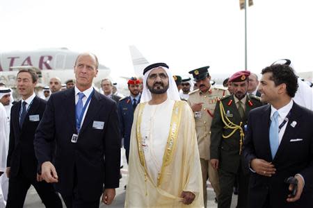 United Arab Emirates' Prime Minister and Ruler of Dubai Sheikh Mohammed bin Rashid al-Maktoum (front, 2nd R) walks with EADS Chief Executive Tom Enders (2nd L) while on a tour at the opening of the Dubai Airshow November 17, 2013. REUTERS/Ahmed Jadallah