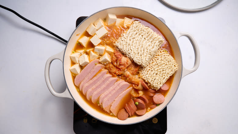 noodles in budae jjigae pot