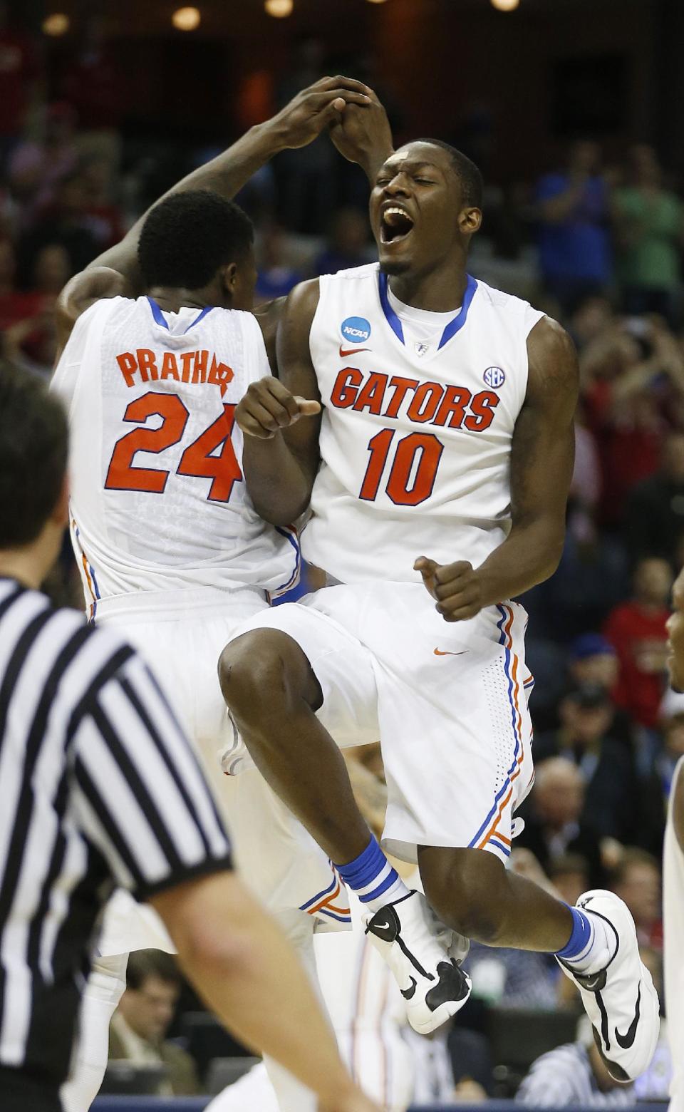 Florida's Casey Prather (24) Dorian Finney-Smith (10) celebrate after the second half in a regional final game against Dayton at the NCAA college basketball tournament, Saturday, March 29, 2014, in Memphis, Tenn. Florida won 62-52. (AP Photo/John Bazemore)