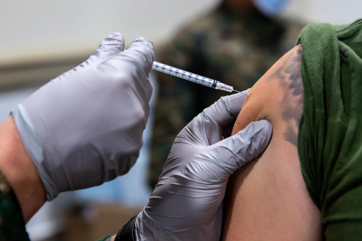 A Navy corpsman with 2d Marine Division administers a COVID-19 vaccine to a Marine at Camp Lejeune, Jan. 22, 2021.