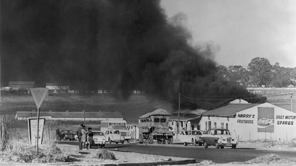 A picture dated August 1976 in Soweto shows buildings burning during a Black students' protest against having to use the Afrikaans language at school. - Mike Mizleni/AFP/Getty Images